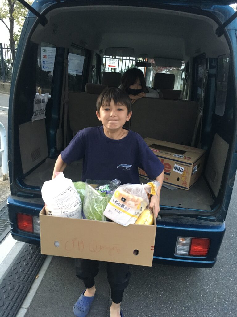 Kozmoz Volunteer delivering a family care box
