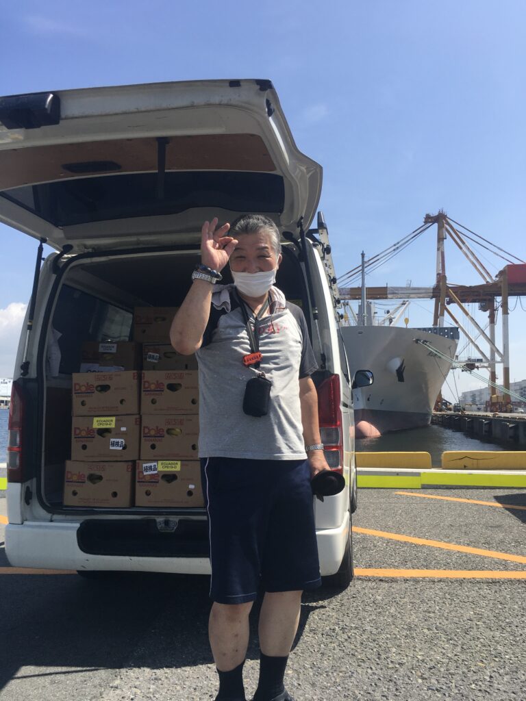 Kyoto Kozmoz Food Bank volunteer Hori San with delivery truck at Kobe port
